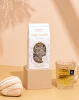 Organic Colic Soothe Tea on a warm beige studio background.