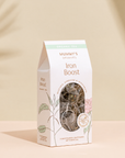 Organic Iron Boost Tea on a warm beige studio background.