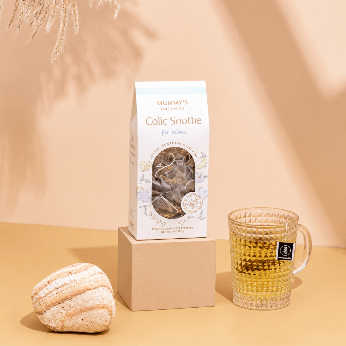 Organic Colic Soothe Tea on a warm beige studio background.