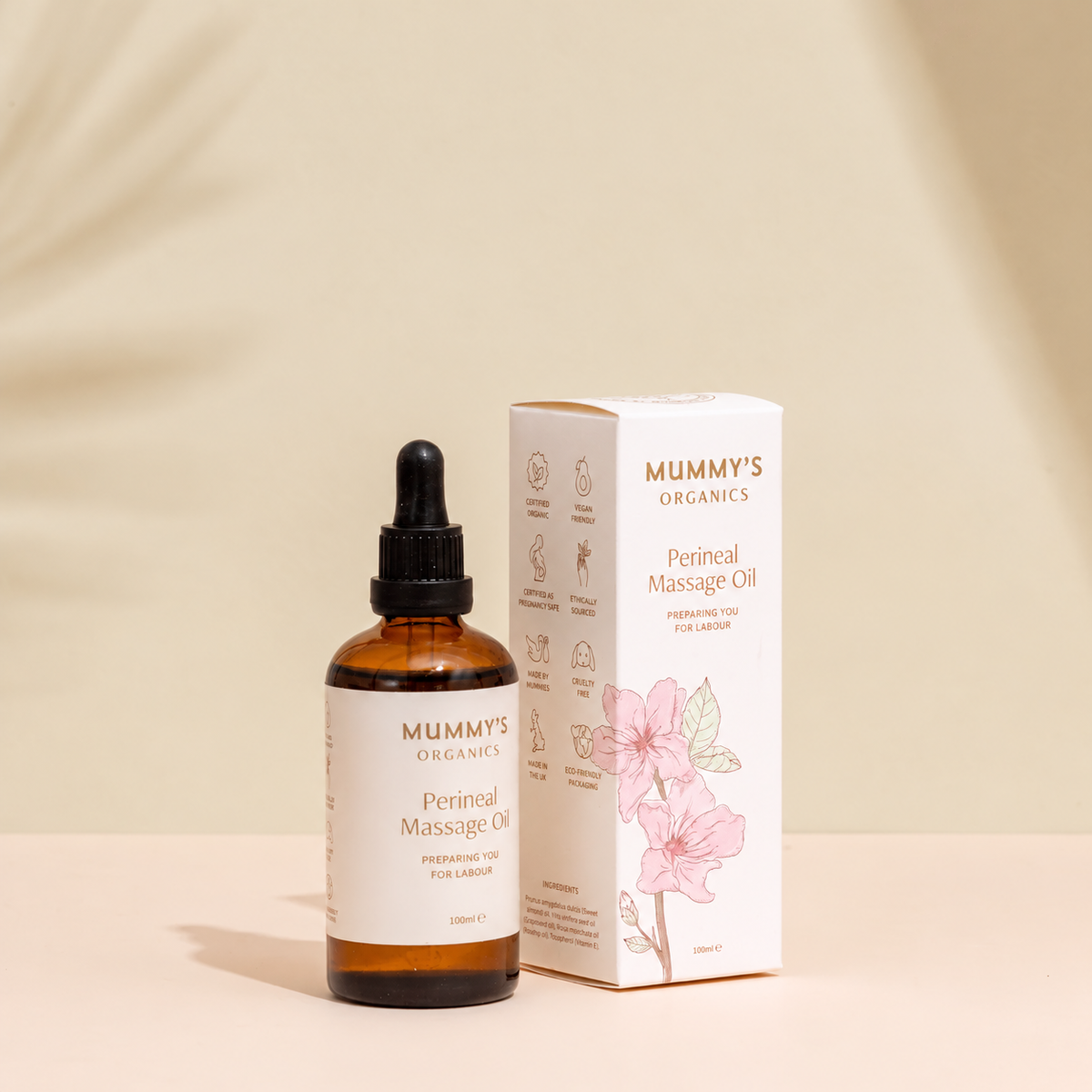Organic Perineal Massage Oil on a warm beige studio background.